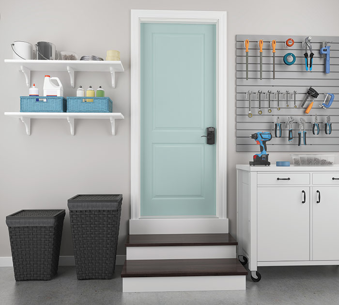 Organized garage with door leading to the home protected with a keyless electronic lock.